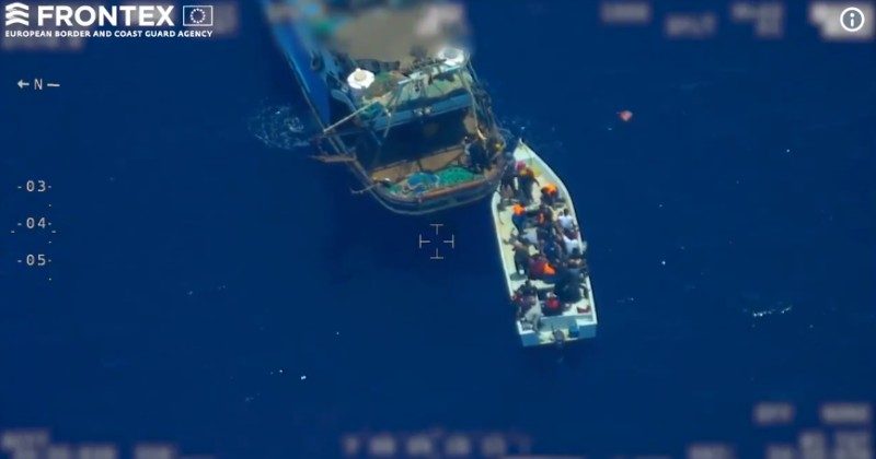 caught! criminal human smugglers filling up smaller boat